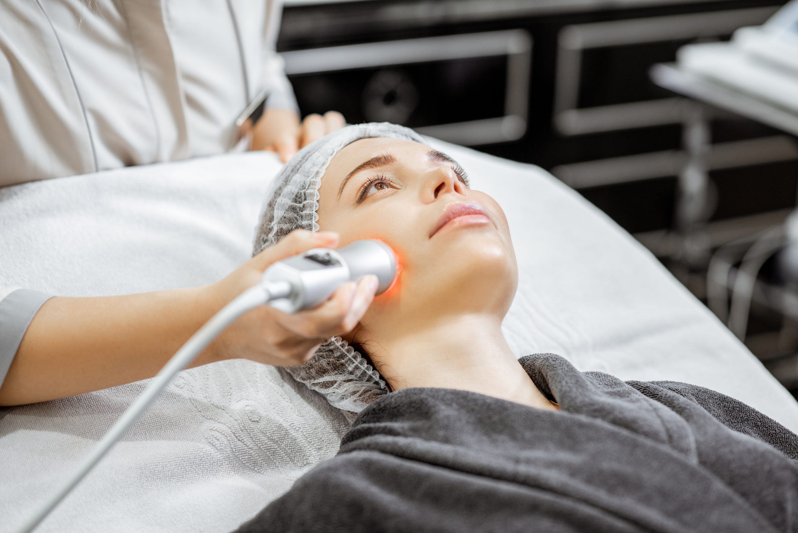 Woman during the oxygen mesotherapy procedure at the beauty salon, close-up view. Concept of a professional facial treatment