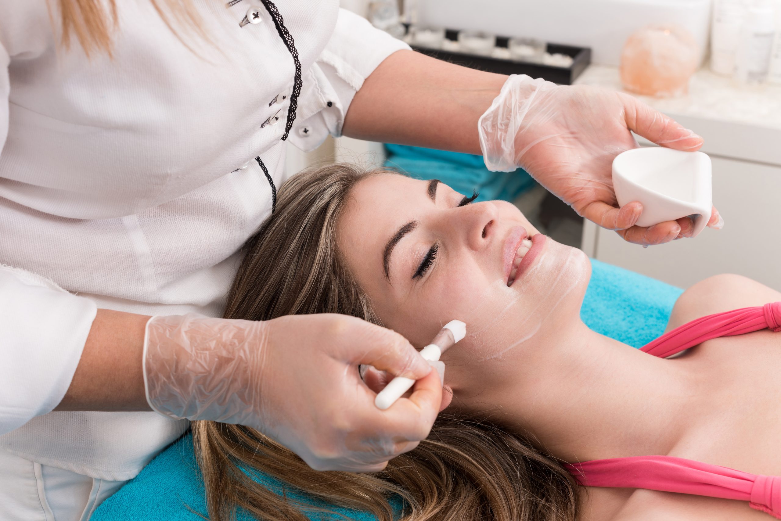 Woman having a facial massage and peeling in beauty salon